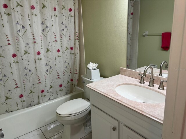 full bathroom featuring vanity, shower / bath combo, and toilet