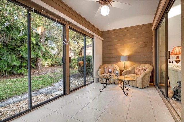 unfurnished sunroom featuring ceiling fan