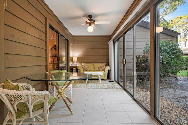 sunroom / solarium featuring ceiling fan