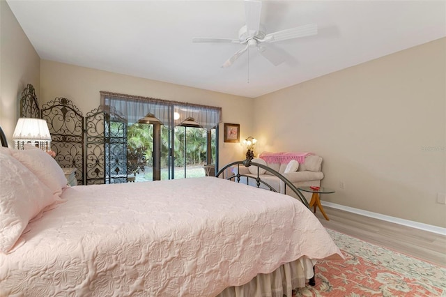 bedroom featuring hardwood / wood-style flooring, ceiling fan, and access to outside