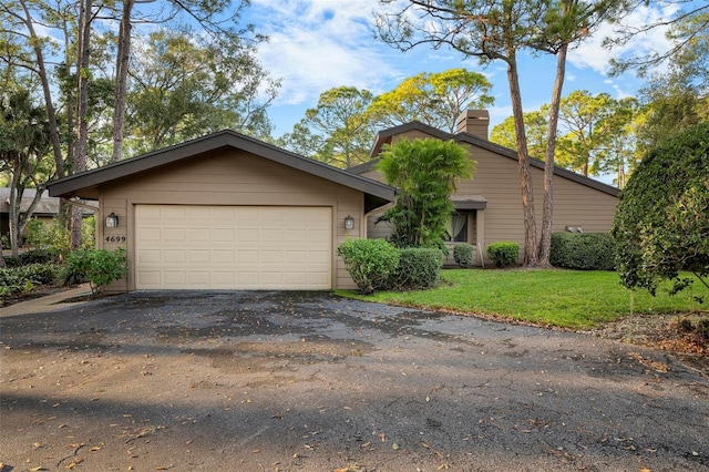 view of front of property with a front lawn and a garage