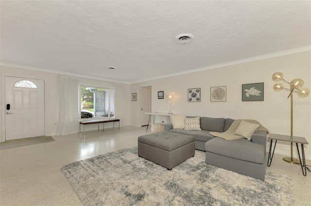 living room with a textured ceiling and ornamental molding