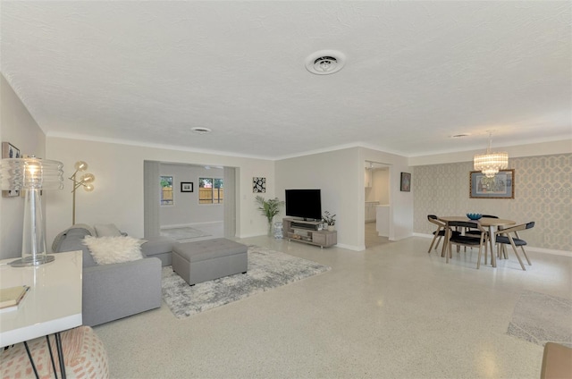 living room with a textured ceiling and a notable chandelier