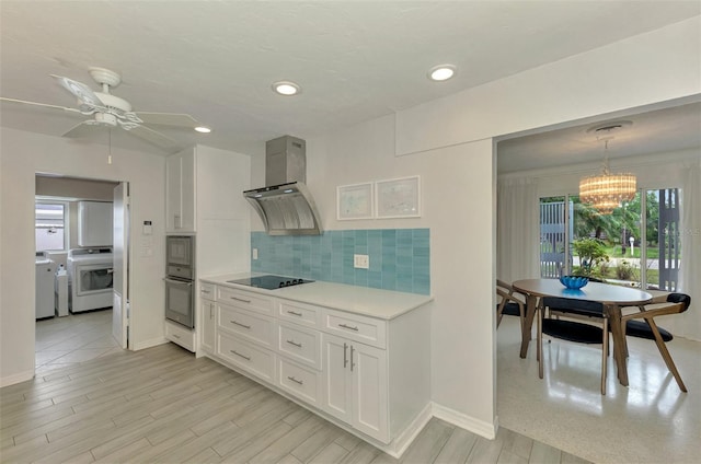 kitchen featuring stainless steel oven, tasteful backsplash, independent washer and dryer, extractor fan, and white cabinets