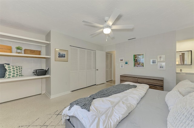 bedroom with ceiling fan and a textured ceiling