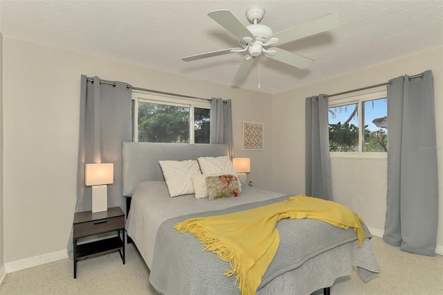 bedroom with multiple windows and ceiling fan