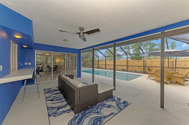 view of pool featuring a lanai, ceiling fan, and a patio area