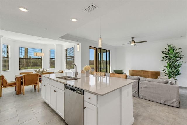 kitchen featuring stainless steel dishwasher, sink, hanging light fixtures, an island with sink, and white cabinets