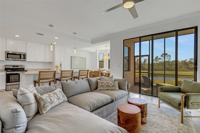 living room with ceiling fan, light tile patterned floors, and crown molding