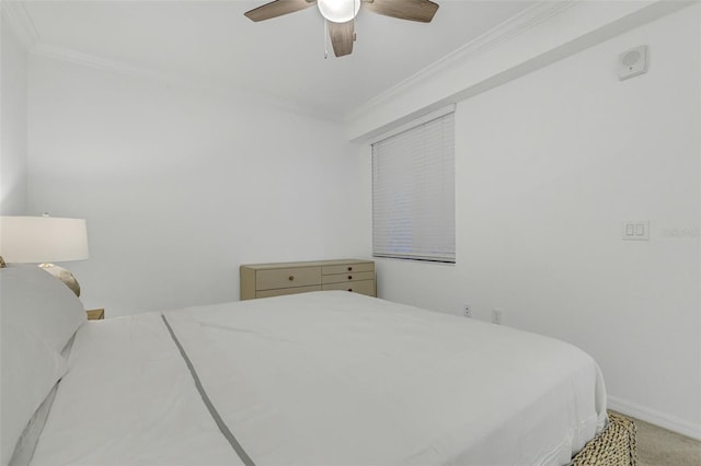 bedroom featuring ceiling fan, carpet, and crown molding