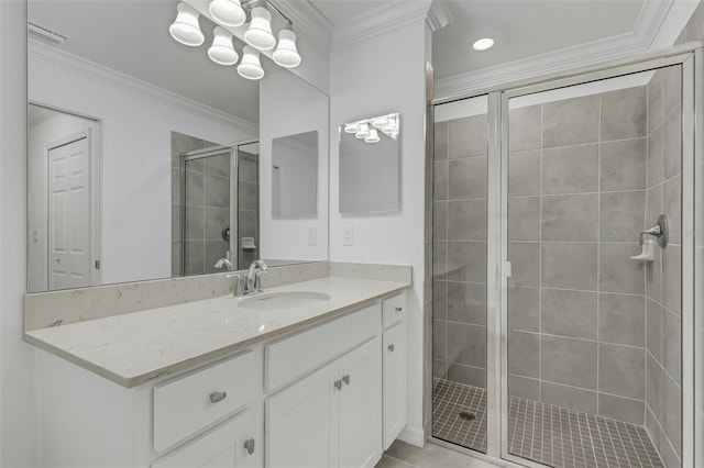 bathroom featuring an enclosed shower, vanity, ornamental molding, and tile patterned flooring