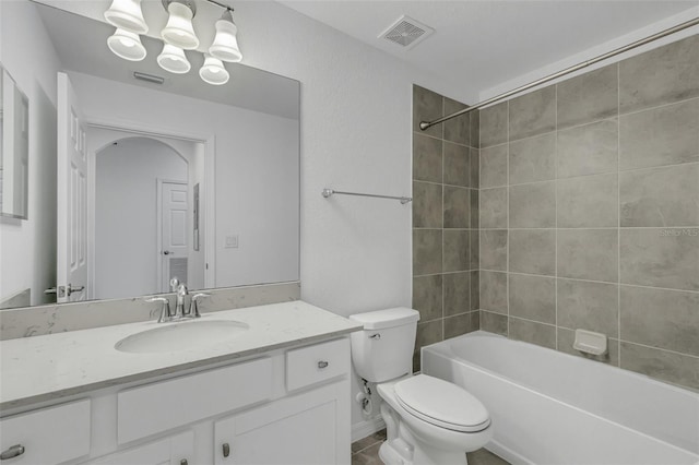 full bathroom featuring tiled shower / bath combo, vanity, and toilet