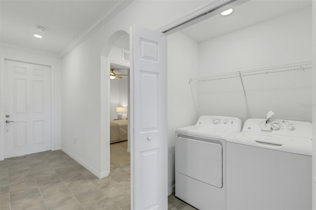 laundry room featuring ceiling fan, washer and dryer, and crown molding