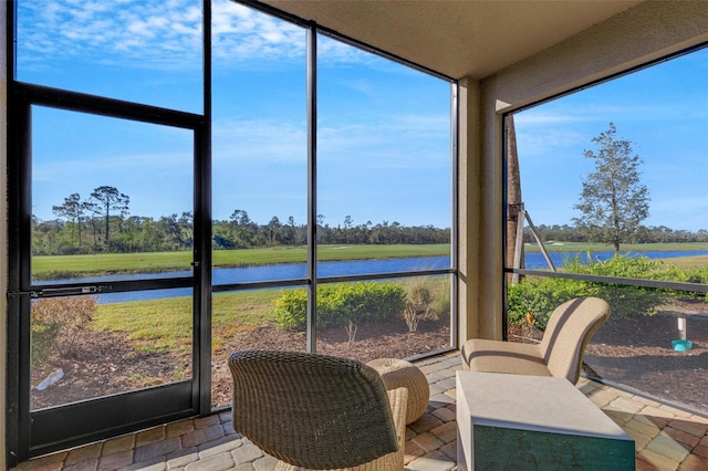 sunroom / solarium with a water view and plenty of natural light