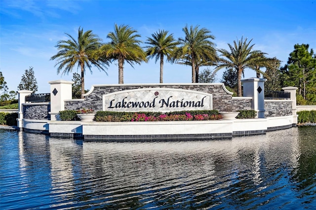 community / neighborhood sign with a water view