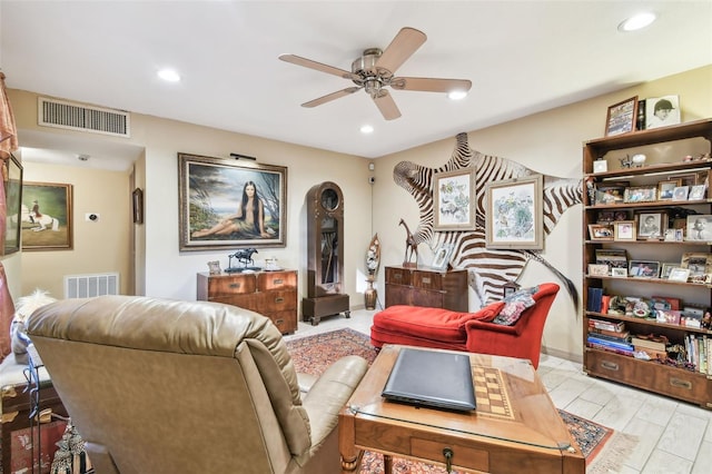 living room with light wood-type flooring and ceiling fan