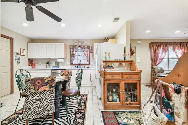 kitchen featuring sink, white cabinetry, and light tile patterned flooring