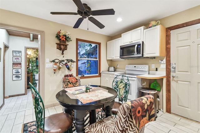 kitchen with white cabinets, white range with electric stovetop, and ceiling fan