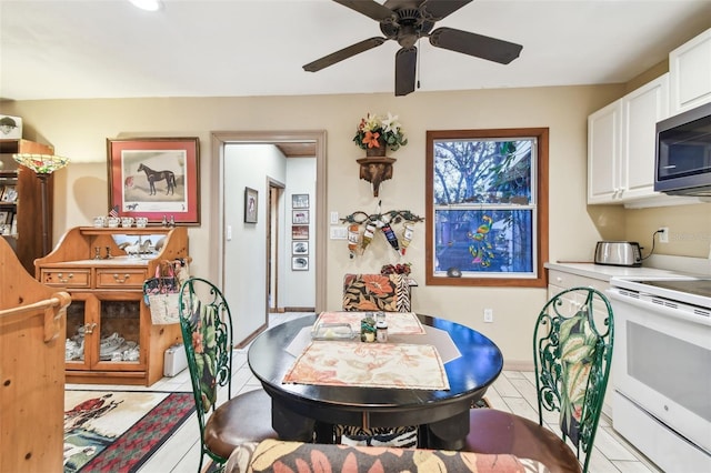 tiled dining area featuring ceiling fan