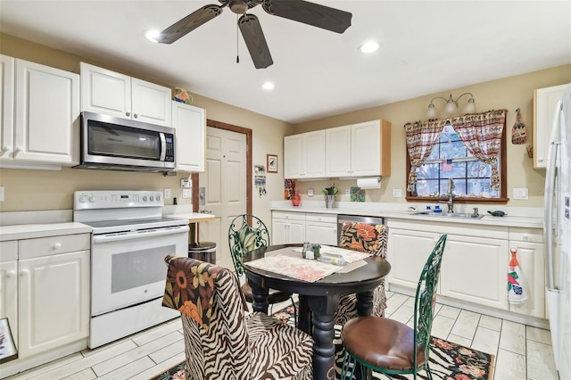 kitchen featuring white cabinets, ceiling fan, sink, and appliances with stainless steel finishes