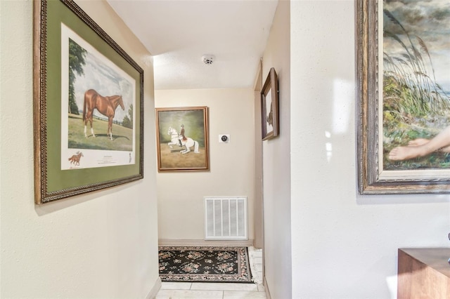 hall featuring light tile patterned floors