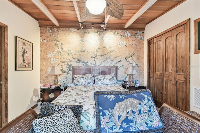 bedroom featuring a closet, beamed ceiling, and wood ceiling