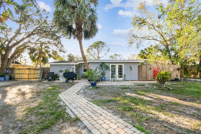 rear view of property with french doors