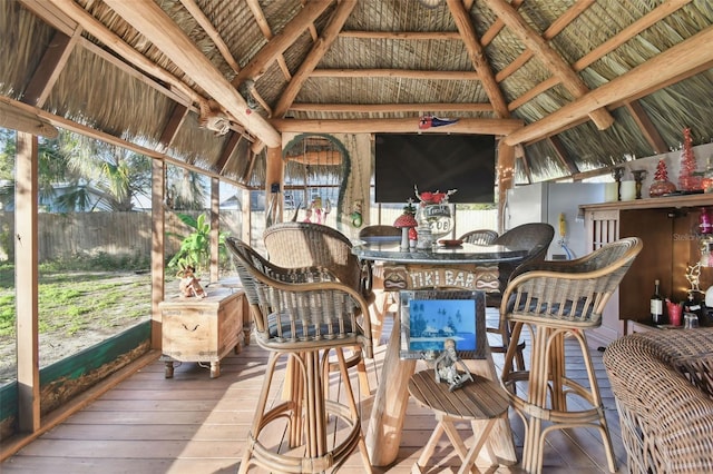 sunroom with lofted ceiling with beams and wooden ceiling