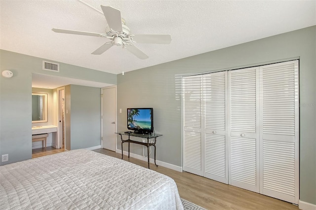 bedroom with ceiling fan, a closet, a textured ceiling, and light wood-type flooring