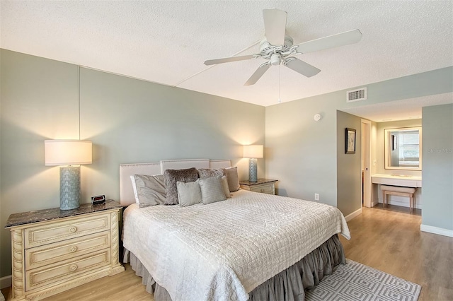 bedroom featuring ceiling fan, a textured ceiling, and light wood-type flooring