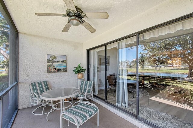 sunroom featuring ceiling fan