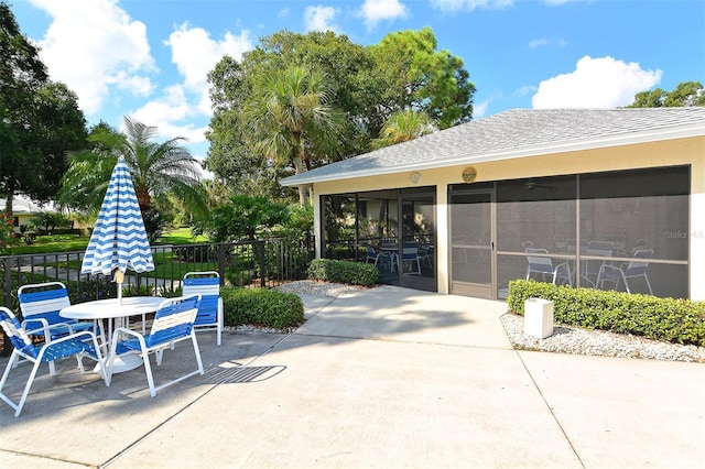 view of patio featuring a sunroom