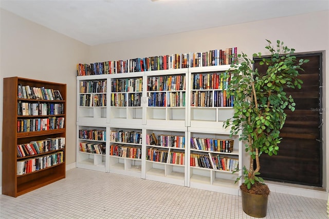 living area with tile patterned floors