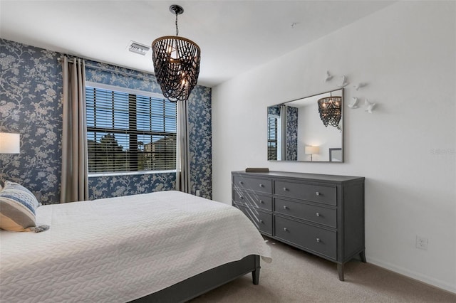 bedroom with light carpet and an inviting chandelier