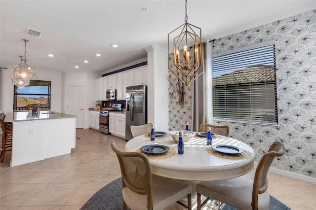 dining room with light tile patterned floors, a notable chandelier, sink, and crown molding