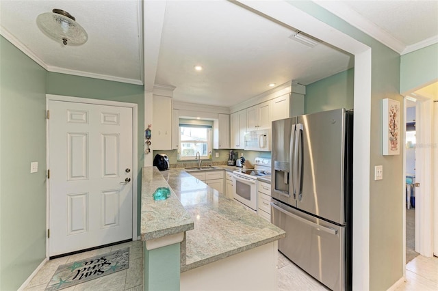 kitchen with white appliances, white cabinetry, ornamental molding, and sink