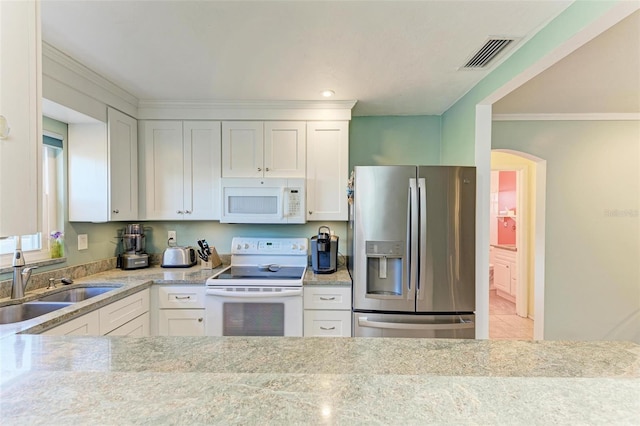 kitchen with white cabinetry, light stone countertops, white appliances, and sink