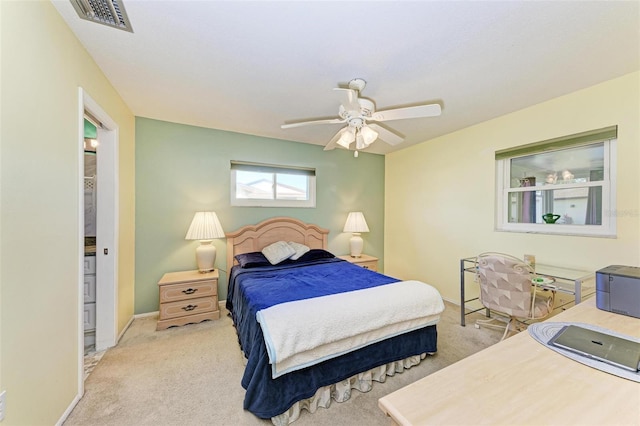 bedroom with ceiling fan and light carpet