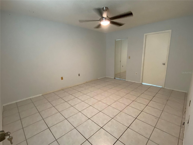 unfurnished room featuring ceiling fan and light tile patterned floors