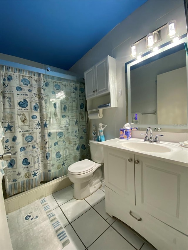 bathroom featuring tile patterned floors, vanity, and toilet