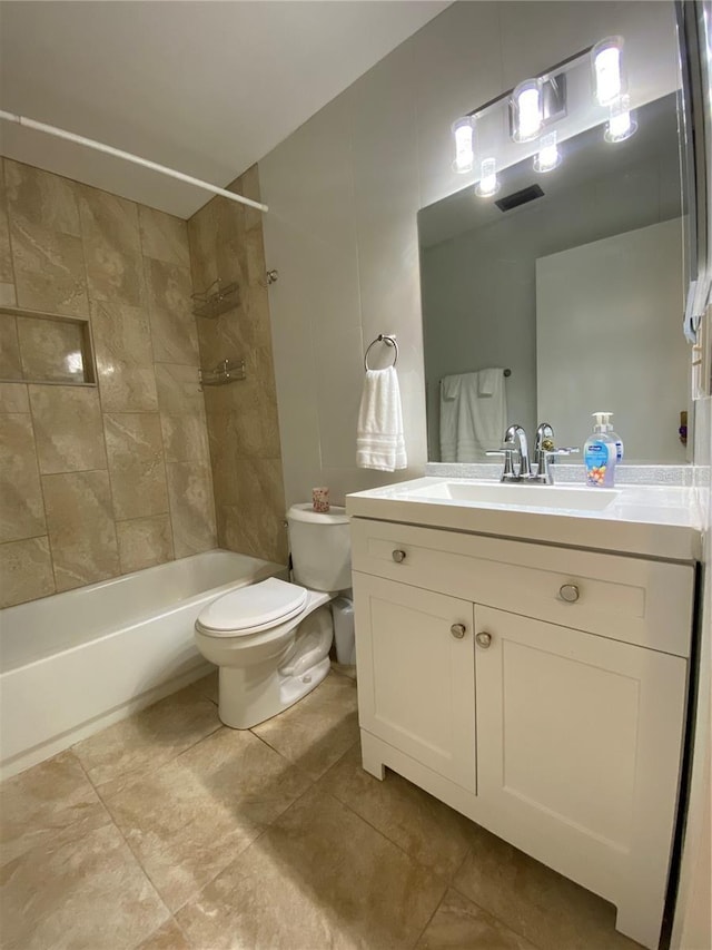 full bathroom with vanity, tiled shower / bath combo, and toilet