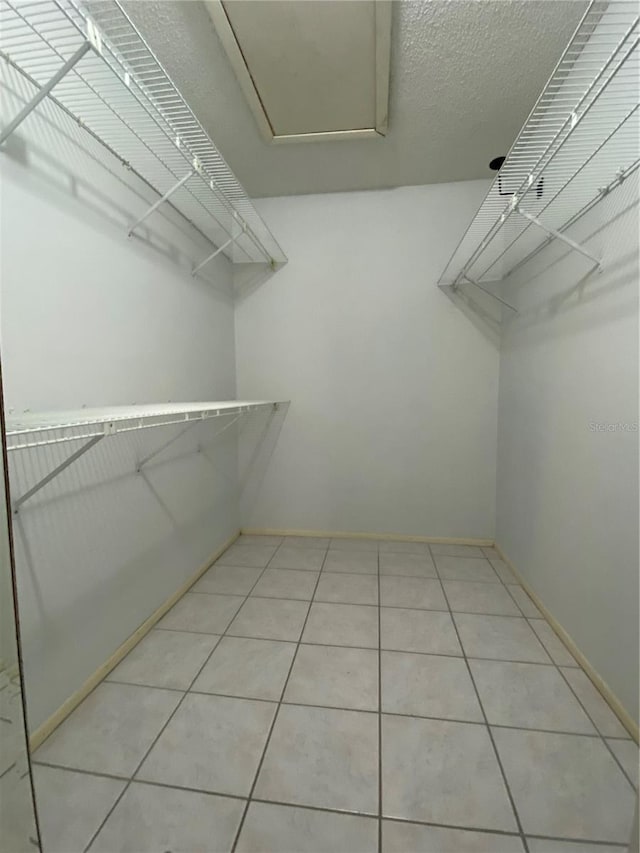 spacious closet featuring light tile patterned floors
