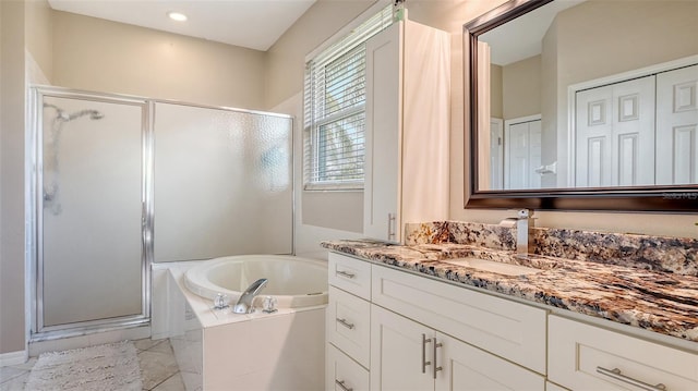 bathroom featuring vanity and shower with separate bathtub