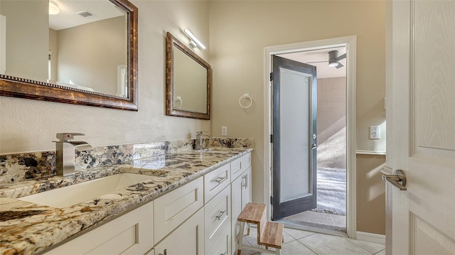 bathroom featuring tile patterned floors, ceiling fan, and vanity