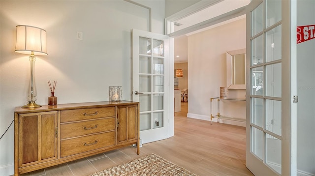 entryway with french doors and light hardwood / wood-style floors