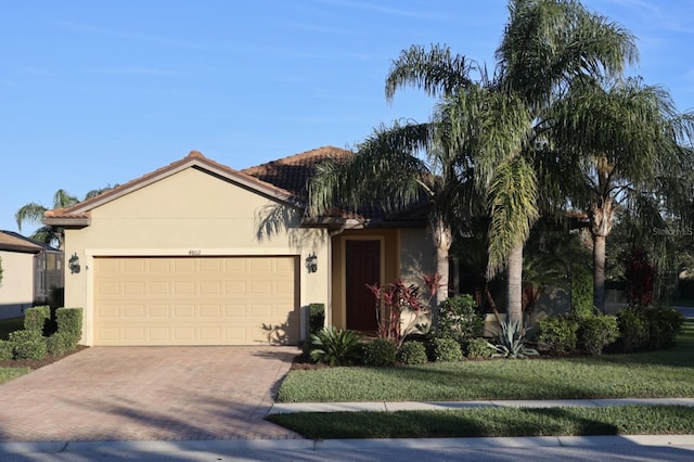 view of front of home with a front yard and a garage