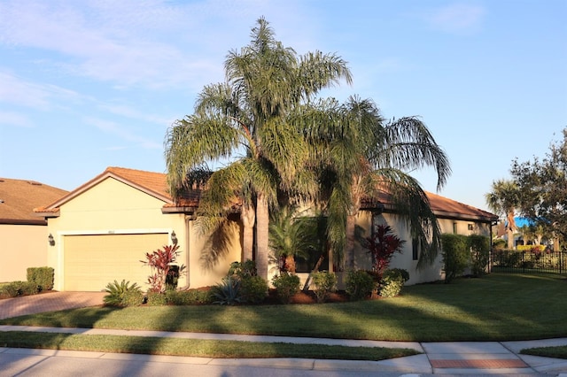 view of front facade featuring a front yard and a garage