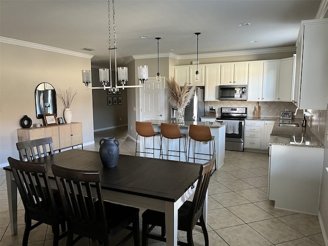 tiled dining space with an inviting chandelier, ornamental molding, and sink