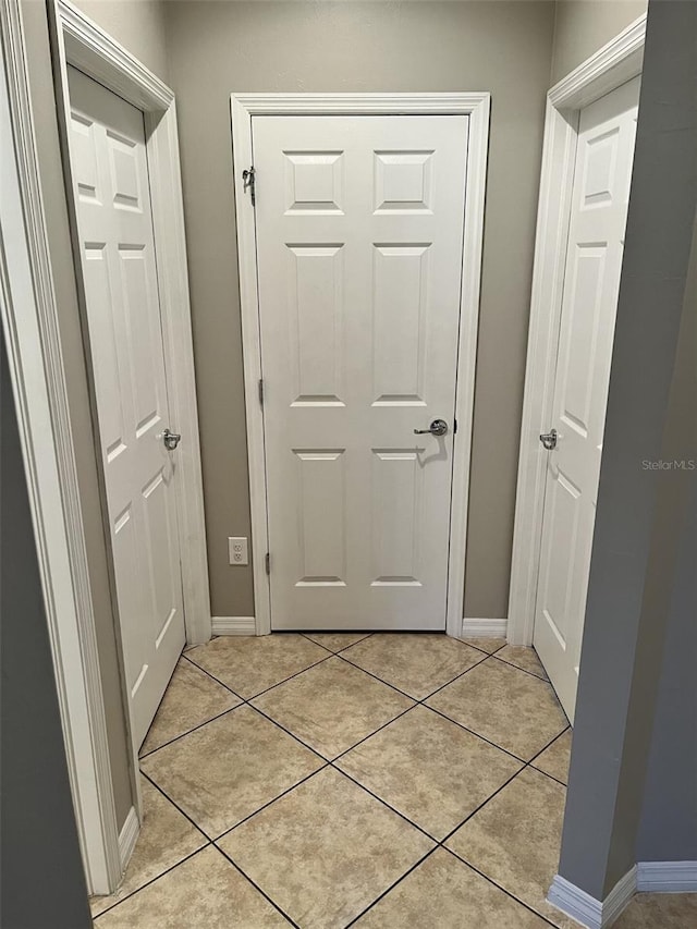 hallway with light tile patterned floors