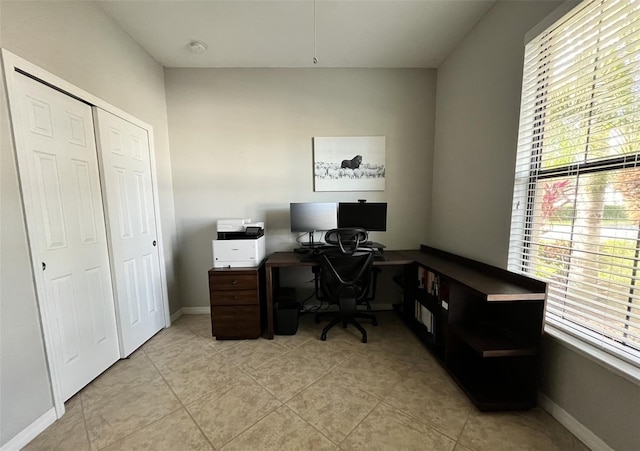 tiled home office featuring a healthy amount of sunlight